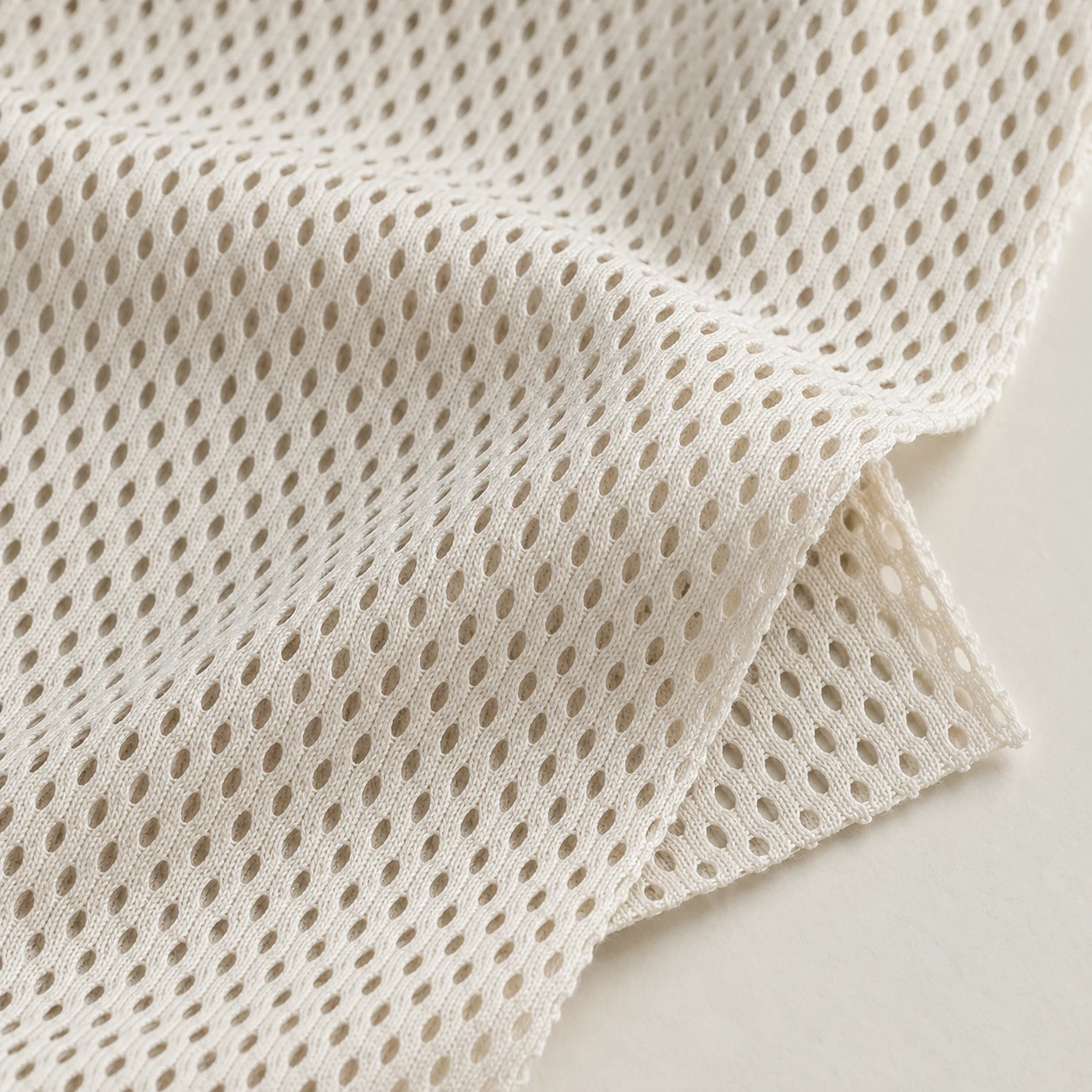 Representative open athletic mesh texture; generated illustration.