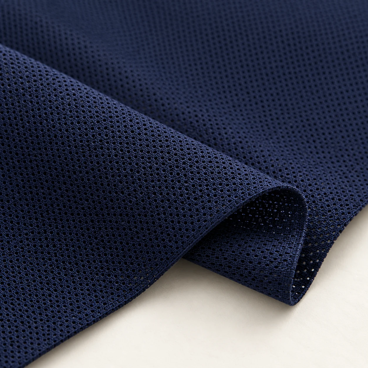 Representative birdseye / pin-dot mesh texture; generated illustration.